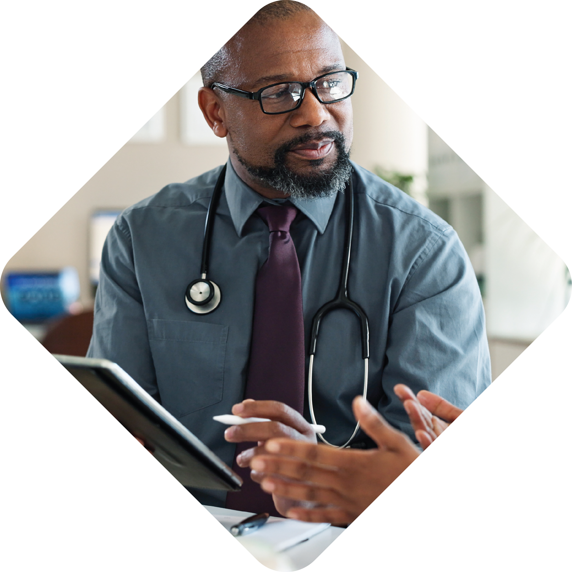A photo of a male physician looking at an off-screen patient